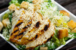 Close Up Caesar salad with chicken and lettuce on wooden table