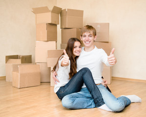 happy young family showing thumbs up on a background of cardboar