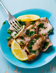 Canvas Print - grilled calamary a grill with parsley and a lemon