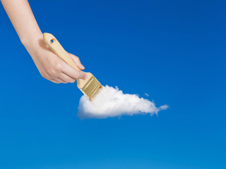 Wall Mural - paintbrush paints solitary white cloud in blue sky