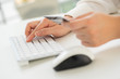 © alice_photo - Hands of an office woman typing keyboard with credit card