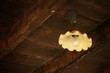 Antique Metal Light Hanging From Old Wooden Barn Ceiling