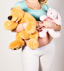  pregnant woman with  toy on her belly