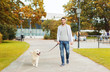 © Syda Productions - happy man with labrador dog walking in city park
