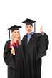 © Ljupco Smokovski - Delighted man and woman in graduation gowns