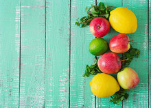 Ripe Fruits (apples, Lemons And Limes) On A Bright Wooden Background. Top View