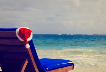 Wall Mural - chair lounge with red Santa hat on beach