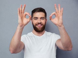 Wall Mural - Happy man showing ok sign with fingers