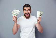 Cheerful Man Holding Dollar Bills