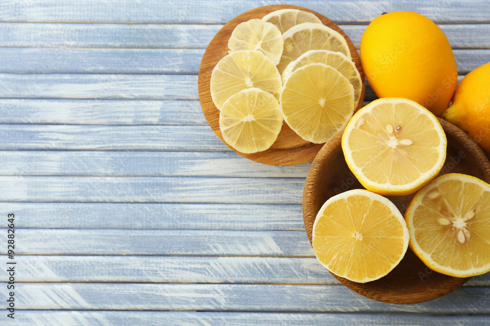 Ripe lemons on wooden table close up
