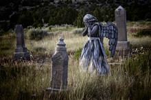 Girl Wearing An Angel Costume In An Old Grave Yard