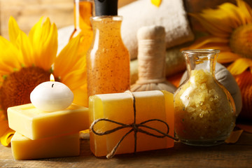 Poster - Spa treatments and sunflower on wooden background