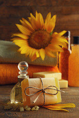 Poster - Spa treatments and sunflower on wooden background