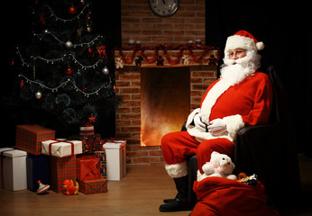 Wall Mural - Santa Claus brought gifts for Christmas and having a rest 