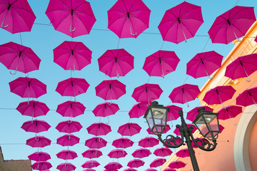  Many open umbrellas flying in the sky, giving idea of protection, Italy