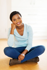 Wall Mural - african american woman sitting on floor in new house
