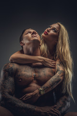 Wall Mural - Tattooed man and blond woman.