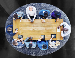 Canvas Print - Group of Diverse People in a Table Using Devices Concept