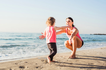 mother and daughter having fun on beach