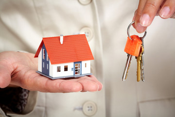 Wall Mural - Woman Hands with little house and key.