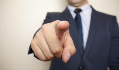 Business man pointing the finger at you, isolated on white backg