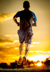 sport man strong legs in off road trail running at amazing summer sunset healthy lifestyle