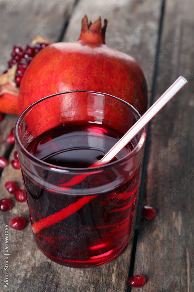 Fresh garnet juice with fruit on wooden table close up