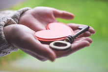 Woman Holding A Heart And A Key