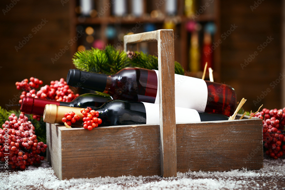 Beautifully decorated box with bottles of wine on unfocused background