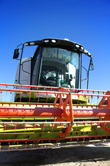 Fototapete - Harvester against the blue sky
