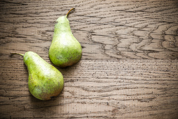 Canvas Print - Halves of green pear on the wooden background