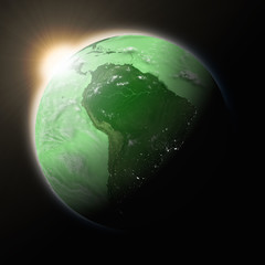 Wall Mural - Sun over South America on green planet Earth