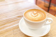 © itim2101 - Cup of coffee latte art on wood table