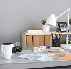 Designers table with camera and tools, cup