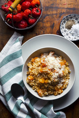 Wall Mural - risotto with pumpkin on a wooden table texture. and red chili pe