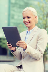 Sticker - smiling businesswoman with tablet pc outdoors