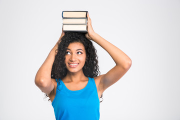 Poster - Happy afro american woman holding books on the head