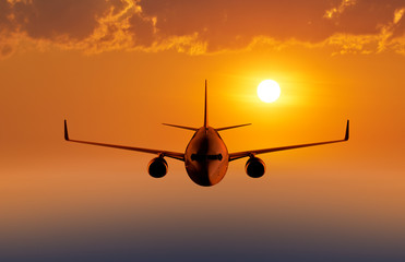 Leinwandbilder - Passenger airplane flying in the evening or morning sky