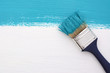 canvas print picture - Stripe of turquoise paint with a paintbrush on white