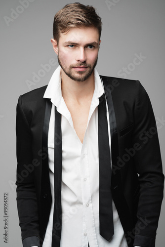 Fototapeta na wymiar Portrait of handsome stylish man in a suit in the studio