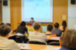 © kenkuza - Motion blur of speaker present project with some audience in a meeting room