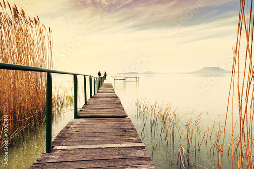 Fotografia  Wooden pier in tranquil lake Balaton