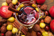 Mulled wine with spices and autumn decor on wooden table. Close up. Selective focus