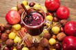Mulled wine with spices and autumn decor on wooden table. Close up. Selective focu