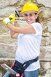 © KikoStock - Woman with helmet and hammer in front of damaged wall