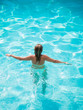 © Netfalls - A girl is relaxing in a swimming pool