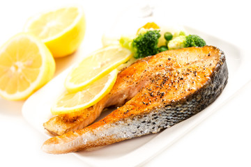 Wall Mural - Grilled salmon and vegetables on plate with lemon