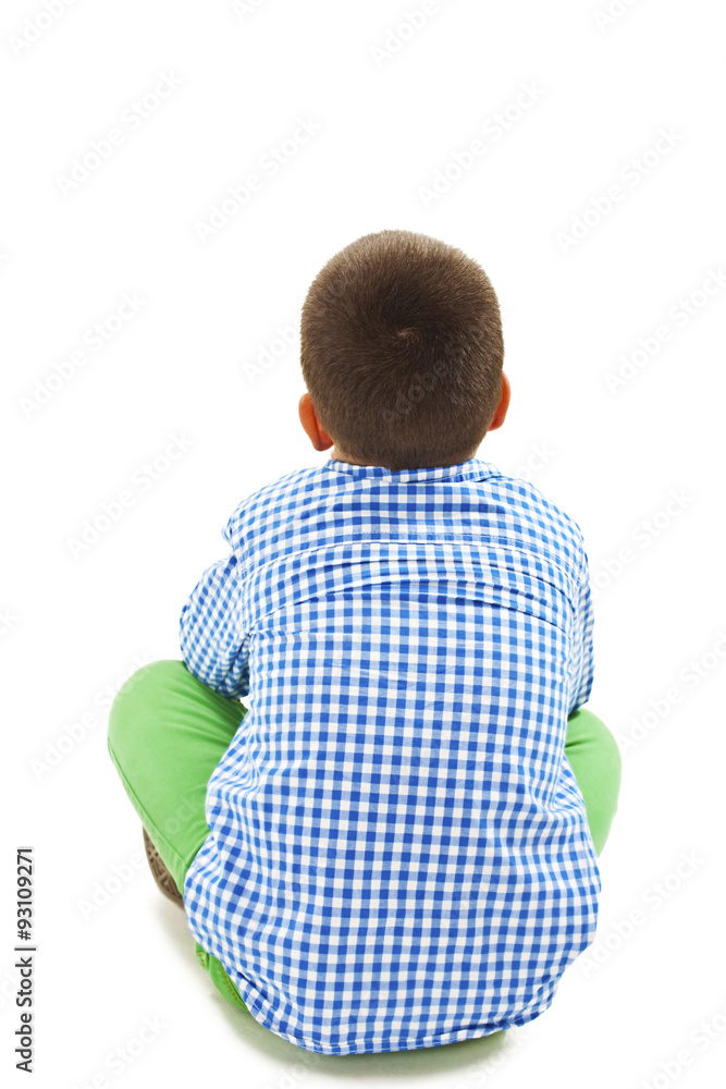 Rear view of little boy sitting on floor. Isolated on white background ...