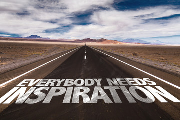 Everybody Needs Inspiration written on desert road