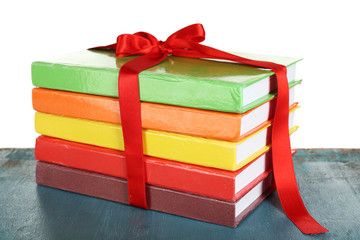 Canvas Print - Stack of books with ribbon on light background